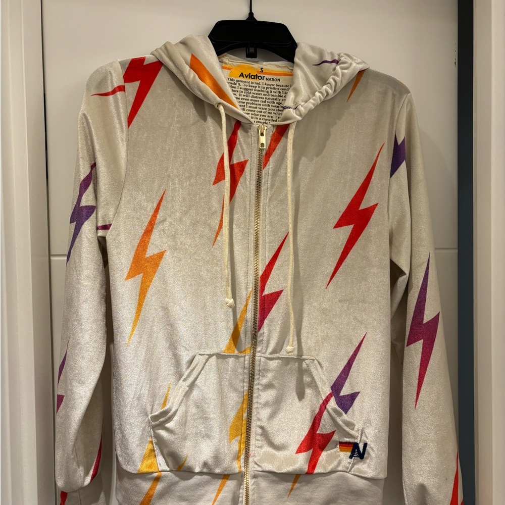 Aviator Nation Cream Hoodie with Red, Orange, and Purple Lightning Bolts